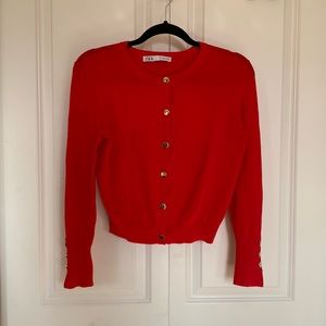 Bright red cardigan with gold buttons